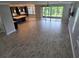 Spacious living room with tile flooring, ceiling fan, and access to the screened patio at 1521 Sourwood Dr, Ocoee, FL 34761