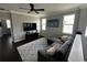 Cozy living room with plush seating, modern ceiling fan, and a large area rug at 1521 Sourwood Dr, Ocoee, FL 34761