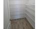 Walk-in pantry with ample shelving for storage, offering organization and convenience at 1521 Sourwood Dr, Ocoee, FL 34761