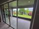 View of the screened patio with landscaping, ceiling fan and access from the main living area at 1521 Sourwood Dr, Ocoee, FL 34761