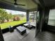 Outdoor screened patio with furniture, ceiling fan, and a view of the landscaping at 1521 Sourwood Dr, Ocoee, FL 34761