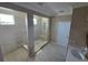 An elegant walk-in shower with glass enclosure and tile surround offers a luxurious bathing experience at 1521 Sourwood Dr, Ocoee, FL 34761