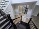 Staircase with wood railing and flooring, a mirror, and white doors at 1521 Sourwood Dr, Ocoee, FL 34761