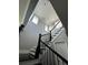 Staircase with black wooden railing and a view of the windows at 1521 Sourwood Dr, Ocoee, FL 34761