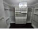 This organized walk-in closet features ample shelving, drawers, and hanging rods at 1521 Sourwood Dr, Ocoee, FL 34761