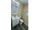 This bathroom has a vanity with a sink and a mirror, as well as a toilet and shelving at 1923 Beechwood Dr, Lakeland, FL 33803