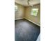Cozy bedroom featuring carpeted floors, a ceiling fan, and large windows offering ample natural light at 1923 Beechwood Dr, Lakeland, FL 33803