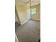 This bedroom features neutral carpeting, a window for natural light, and a double-door closet at 1923 Beechwood Dr, Lakeland, FL 33803