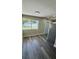Dining area with updated floors, natural light, and stainless steel refrigerator at 1923 Beechwood Dr, Lakeland, FL 33803