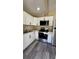 Well-equipped kitchen featuring stainless steel appliances and white cabinets at 1923 Beechwood Dr, Lakeland, FL 33803