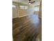 Bright living room featuring wood-look floors, a ceiling fan, and natural light at 1923 Beechwood Dr, Lakeland, FL 33803