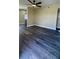 Spacious living room featuring wood-look floors and a modern ceiling fan at 1923 Beechwood Dr, Lakeland, FL 33803