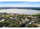 Expansive aerial view of a lake surrounded by lush greenery and a quaint cityscape at 2110 Reaney Rd, Lakeland, FL 33803