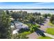 Aerial view of a home with a pool, lush landscaping, and water views in a quiet neighborhood at 2110 Reaney Rd, Lakeland, FL 33803