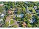 An aerial view showcases a home on a large lot with mature trees in a well-kept neighborhood at 2110 Reaney Rd, Lakeland, FL 33803