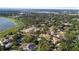 An aerial view of a neighborhood with homes nestled among mature trees and near waterways at 2110 Reaney Rd, Lakeland, FL 33803
