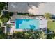 Aerial view of a sparkling swimming pool with manicured landscaping and shaded lounge areas, great for relaxation at 2110 Reaney Rd, Lakeland, FL 33803