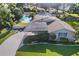 Aerial view of a home with a carport, pool, and well-maintained landscaping at 2110 Reaney Rd, Lakeland, FL 33803