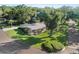 Aerial view of home on large lot with mature trees, manicured lawn, and circular driveway at 2110 Reaney Rd, Lakeland, FL 33803