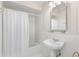 Bathroom with patterned wallpaper, pedestal sink and bathtub with shower at 2110 Reaney Rd, Lakeland, FL 33803