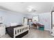 Cozy bedroom features light blue walls, white trim, decor, and a window with exterior natural lighting at 2110 Reaney Rd, Lakeland, FL 33803