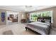 Large bedroom with a view of an outdoor garden through an adjacent seating area at 2110 Reaney Rd, Lakeland, FL 33803