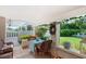 Charming covered patio with cozy seating, perfect for enjoying the serene garden views at 2110 Reaney Rd, Lakeland, FL 33803