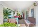 Relaxing covered patio with tile flooring and comfortable seating overlooking the sparkling pool at 2110 Reaney Rd, Lakeland, FL 33803