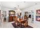 Dining room showcasing chandelier, view to living room, and decorative walls at 2110 Reaney Rd, Lakeland, FL 33803