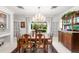 Elegant dining room featuring chandelier, large window, and custom built-in cabinetry at 2110 Reaney Rd, Lakeland, FL 33803