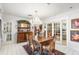 Formal dining room with hutch, decorative chandelier, and view into other rooms at 2110 Reaney Rd, Lakeland, FL 33803