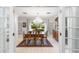 Formal dining room with chandelier, tiled floors, and view of landscaped backyard at 2110 Reaney Rd, Lakeland, FL 33803