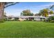 Spacious single-story home with a large, green lawn and a charming, well-maintained facade at 2110 Reaney Rd, Lakeland, FL 33803