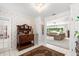 Elegant foyer with vintage cabinet, tile floor and view into the living room at 2110 Reaney Rd, Lakeland, FL 33803