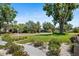 A meticulously landscaped front yard with a winding walkway leads to a charming home, complete with blooming flowers and green shrubs at 2110 Reaney Rd, Lakeland, FL 33803