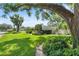 Well-kept front yard with mature trees, manicured lawn, and charming curb appeal in a peaceful neighborhood at 2110 Reaney Rd, Lakeland, FL 33803