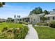 A home featuring a beautifully landscaped front yard, a long driveway, and a well-maintained exterior at 2110 Reaney Rd, Lakeland, FL 33803