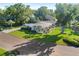 Well-manicured lawn and lush landscaping surround this charming home with a covered carport at 2110 Reaney Rd, Lakeland, FL 33803