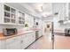 Well-lit kitchen featuring white cabinets, stainless appliances, and a view of adjoining rooms at 2110 Reaney Rd, Lakeland, FL 33803