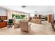 Bright living room with large window overlooking pool and access to other rooms at 2110 Reaney Rd, Lakeland, FL 33803