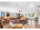 Bright living area with tile floors, two seating areas, a ceiling fan and access to back patio at 2110 Reaney Rd, Lakeland, FL 33803