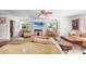 Bright living room features tile floors, comfortable seating, and a large screen TV at 2110 Reaney Rd, Lakeland, FL 33803