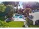 Aerial view of a private backyard pool with patio furniture, lush greenery, and a well-manicured lawn at 2110 Reaney Rd, Lakeland, FL 33803