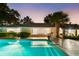 Inviting pool with steps and lounge area, blending seamlessly with the home's design and landscaping at 2110 Reaney Rd, Lakeland, FL 33803