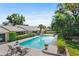 Sparkling pool with lounge chairs, surrounded by lush, mature landscaping, creating a private backyard oasis at 2110 Reaney Rd, Lakeland, FL 33803