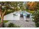 Backyard pool featuring a lush garden with lounge chairs and beautiful hardscape at 2110 Reaney Rd, Lakeland, FL 33803