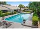Beautiful pool with ample seating surrounded by lush landscaping, creating a serene backyard oasis at 2110 Reaney Rd, Lakeland, FL 33803