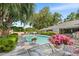 Private pool surrounded by lush landscaping offers a tranquil outdoor retreat at 2110 Reaney Rd, Lakeland, FL 33803