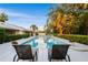 A serene backyard pool area with lounge chairs and meticulous landscaping, perfect for relaxing afternoons at 2110 Reaney Rd, Lakeland, FL 33803