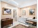 Bathroom vanity with white cabinetry, tiled floor, and vanity lighting at 2110 Reaney Rd, Lakeland, FL 33803